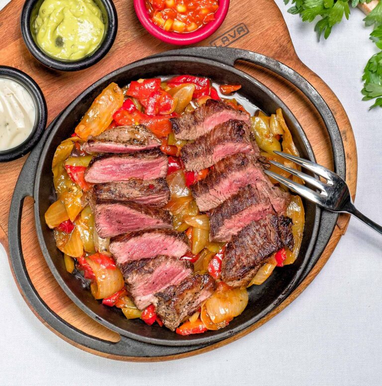 Sliced steak with avocado and dipping sauces